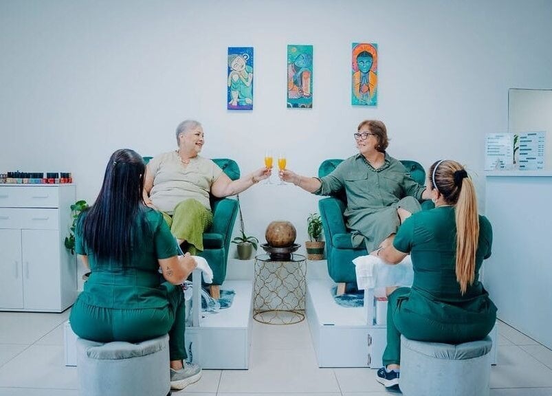 Clients enjoying pedicures with drinks at Kundalini Spa, Noord, AW.