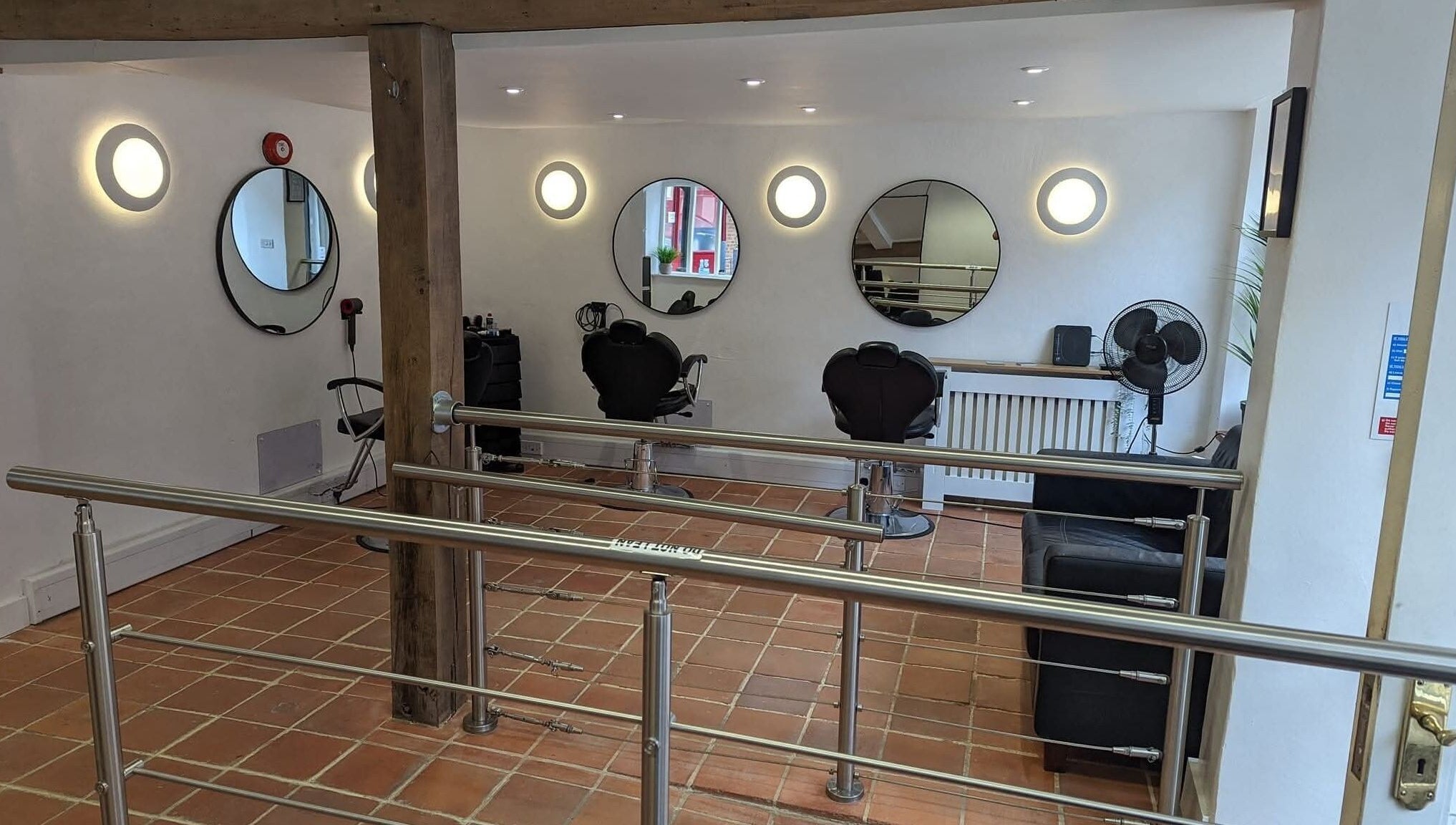 Modern salon interior at chloenortonhair, Dereham, England, GB with stylish mirrors and seating.
