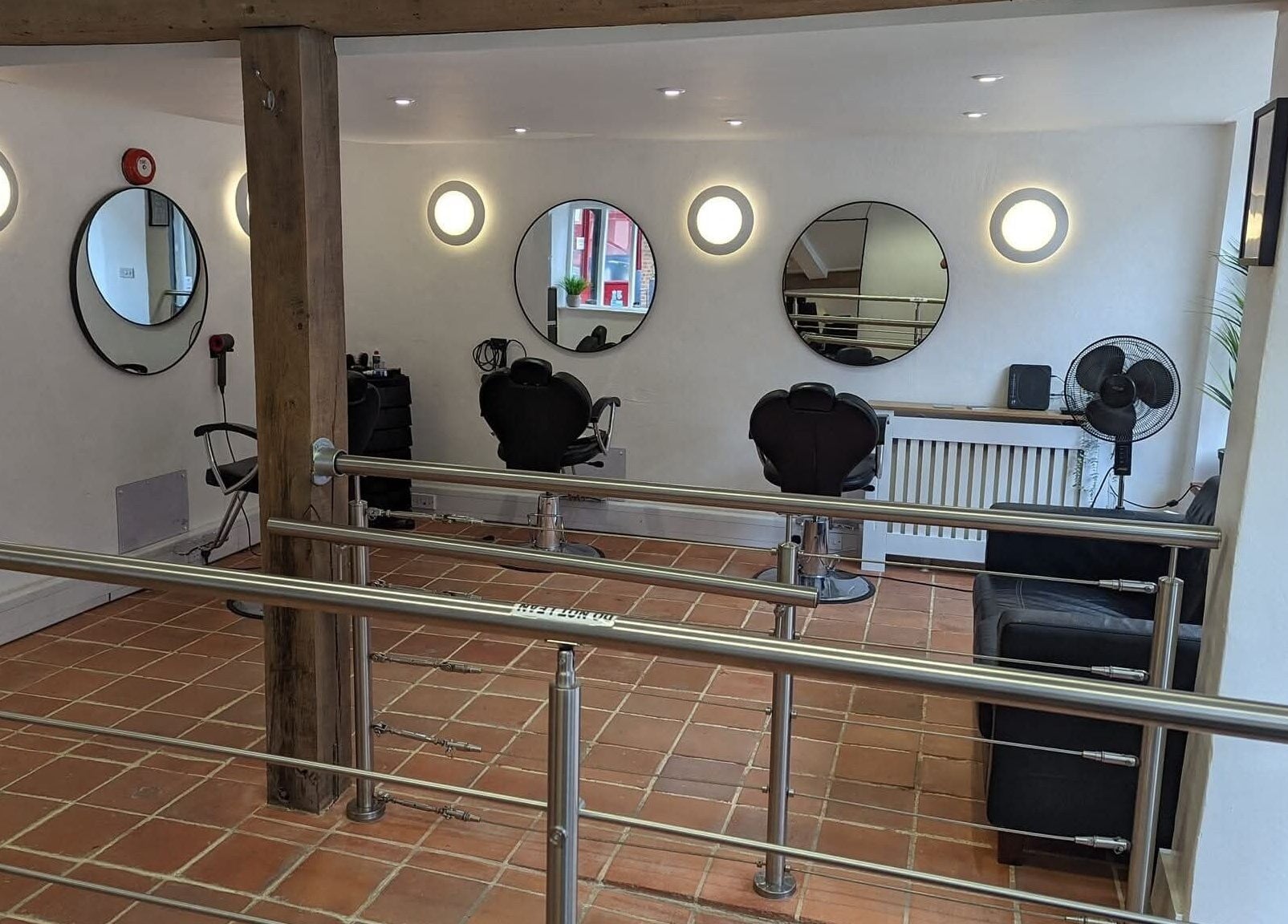 Modern salon interior at chloenortonhair, Dereham, England, GB with stylish mirrors and seating.