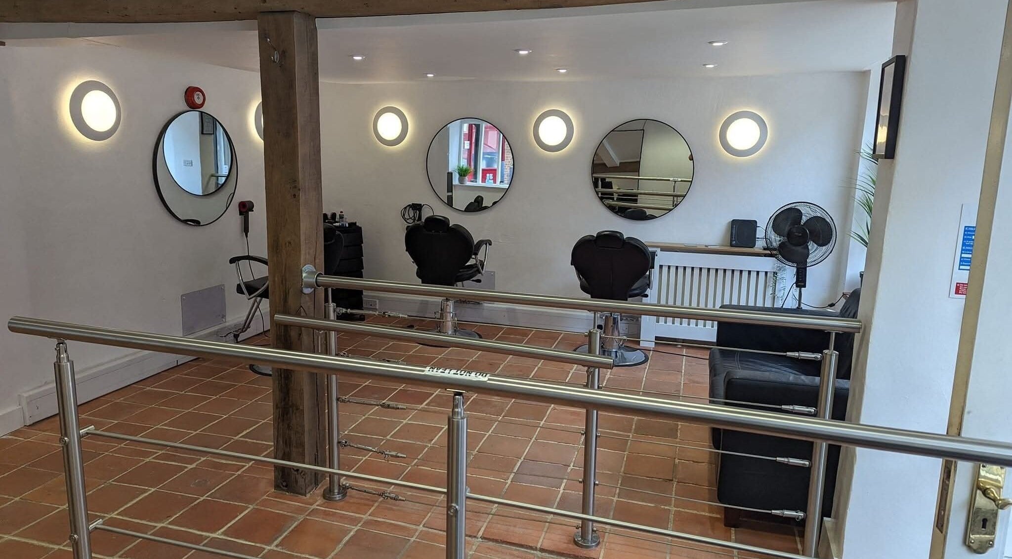 Modern salon interior at chloenortonhair, Dereham, England, GB with stylish mirrors and seating.