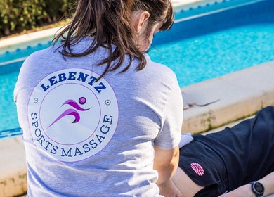 Therapist at Lebentz Sports Massage in Bury St Edmunds, England, GB provides a massage by the pool.