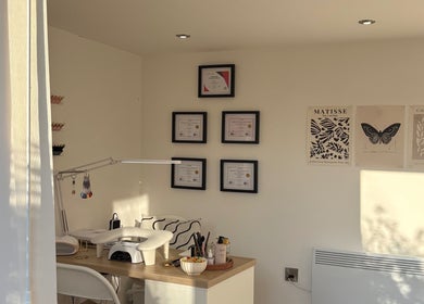 Nail station at Polished by Libs, Beckingham, England, GB with certificates and art on the wall.