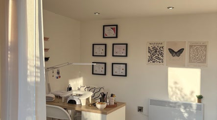 Nail station at Polished by Libs, Beckingham, England, GB with certificates and art on the wall.