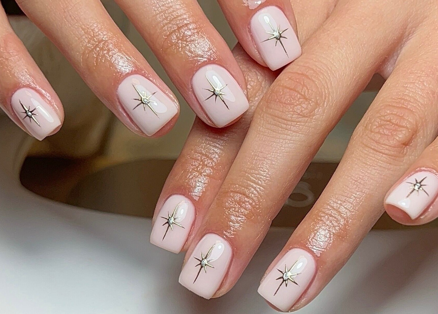 Elegant starry nail art at Coco Nail Studio, Cardiff, Wales, GB. Perfect blend of beauty and style.