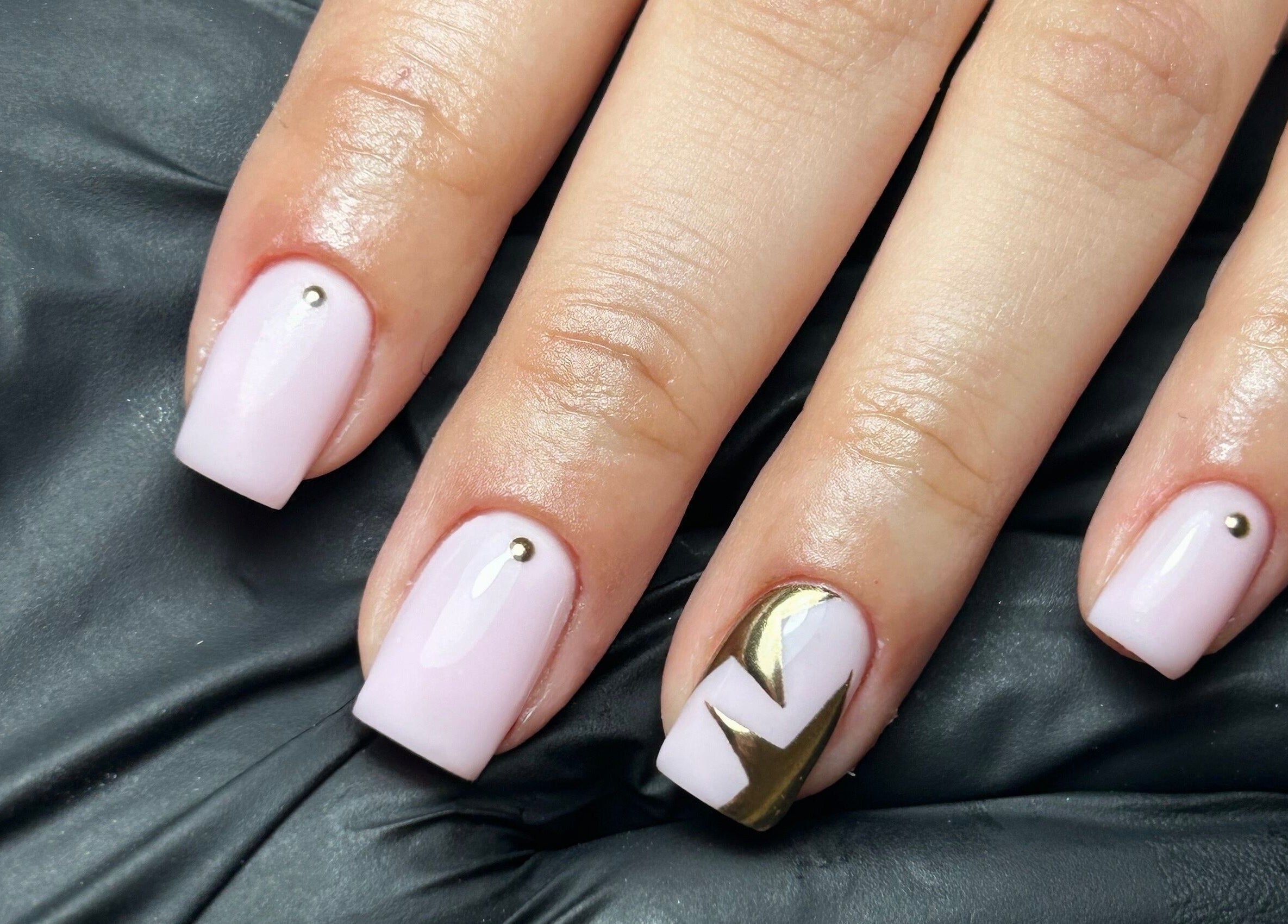 Elegant nail art with gold accents at Coco Nail Studio, Cardiff, Wales, GB.