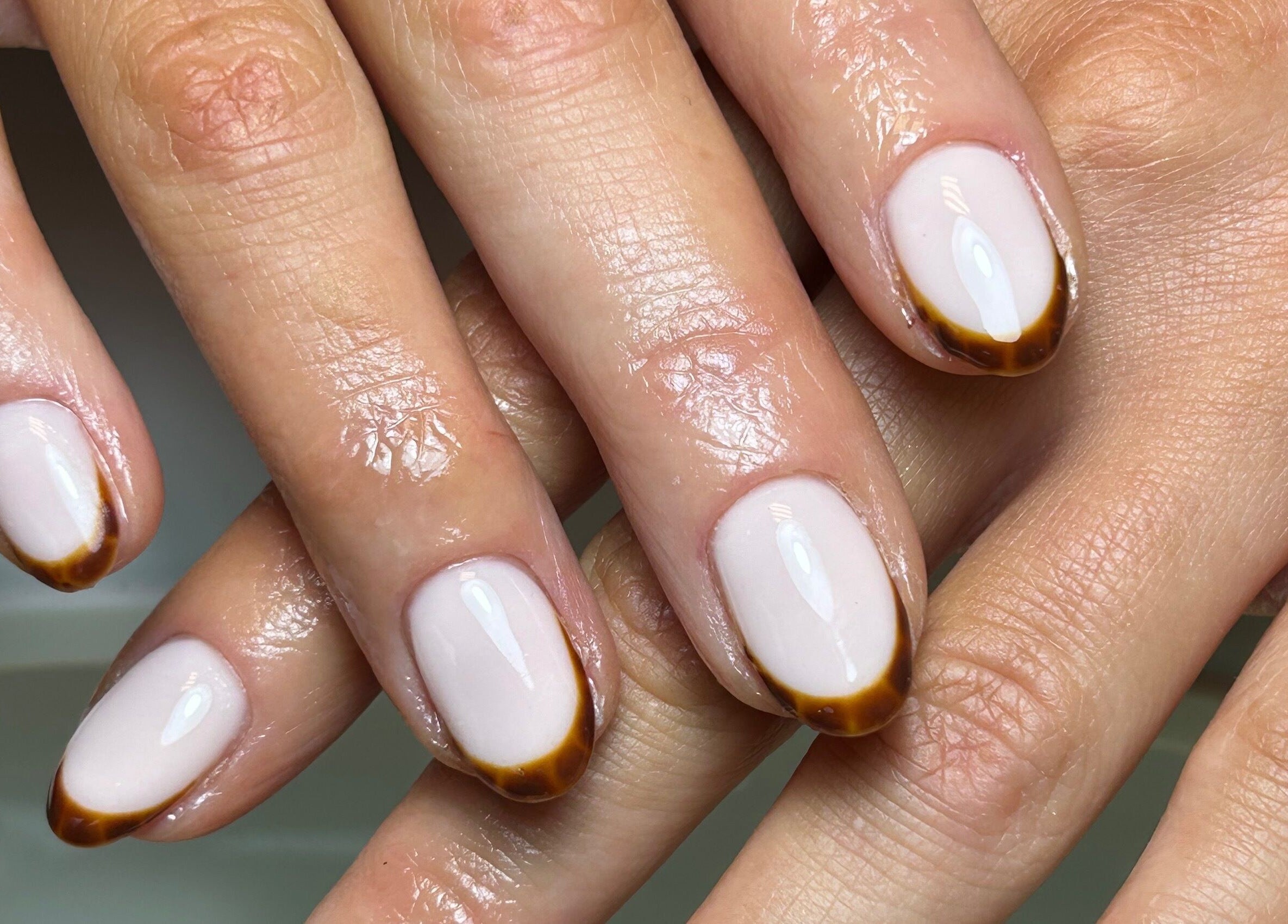 Elegant French manicure at Coco Nail Studio, Cardiff, Wales, GB. Features minimalist brown-tipped nails.