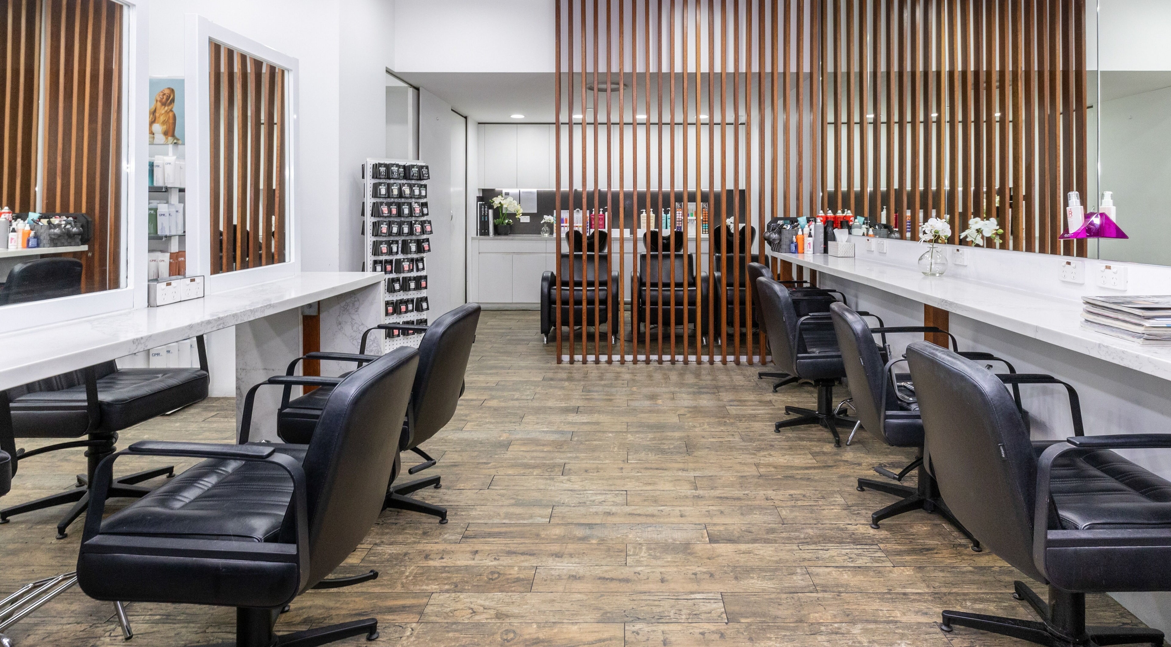 Modern salon interior at Hair Scissors Piercings in Bondi Junction, NSW, AU with sleek chairs and mirrors.