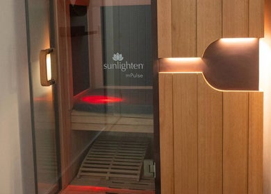 Wooden sauna door at Cryo Revive Manchester with Sunlighten logo, Manchester, England, GB.