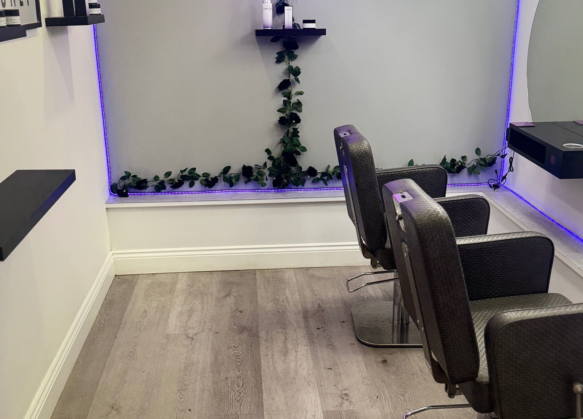 Modern salon chairs with purple LED lights at Hairvibes, Hazlemere, England, GB.