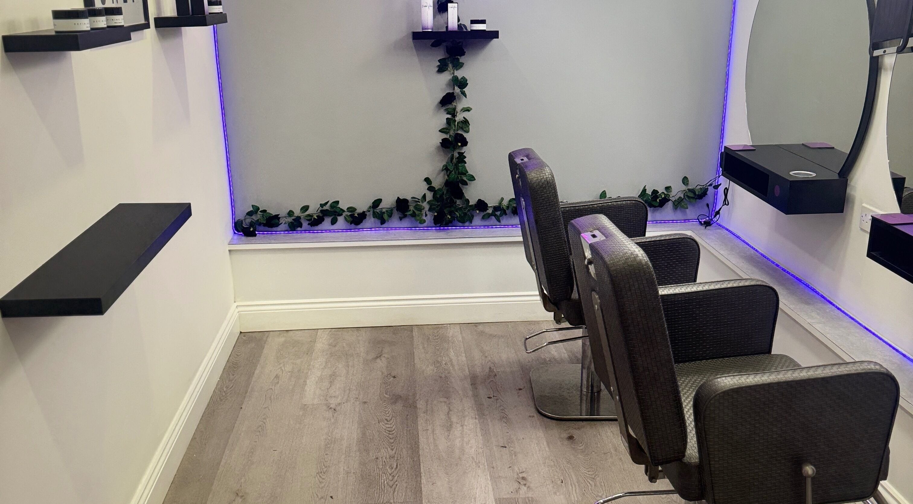 Modern salon chairs with purple LED lights at Hairvibes, Hazlemere, England, GB.