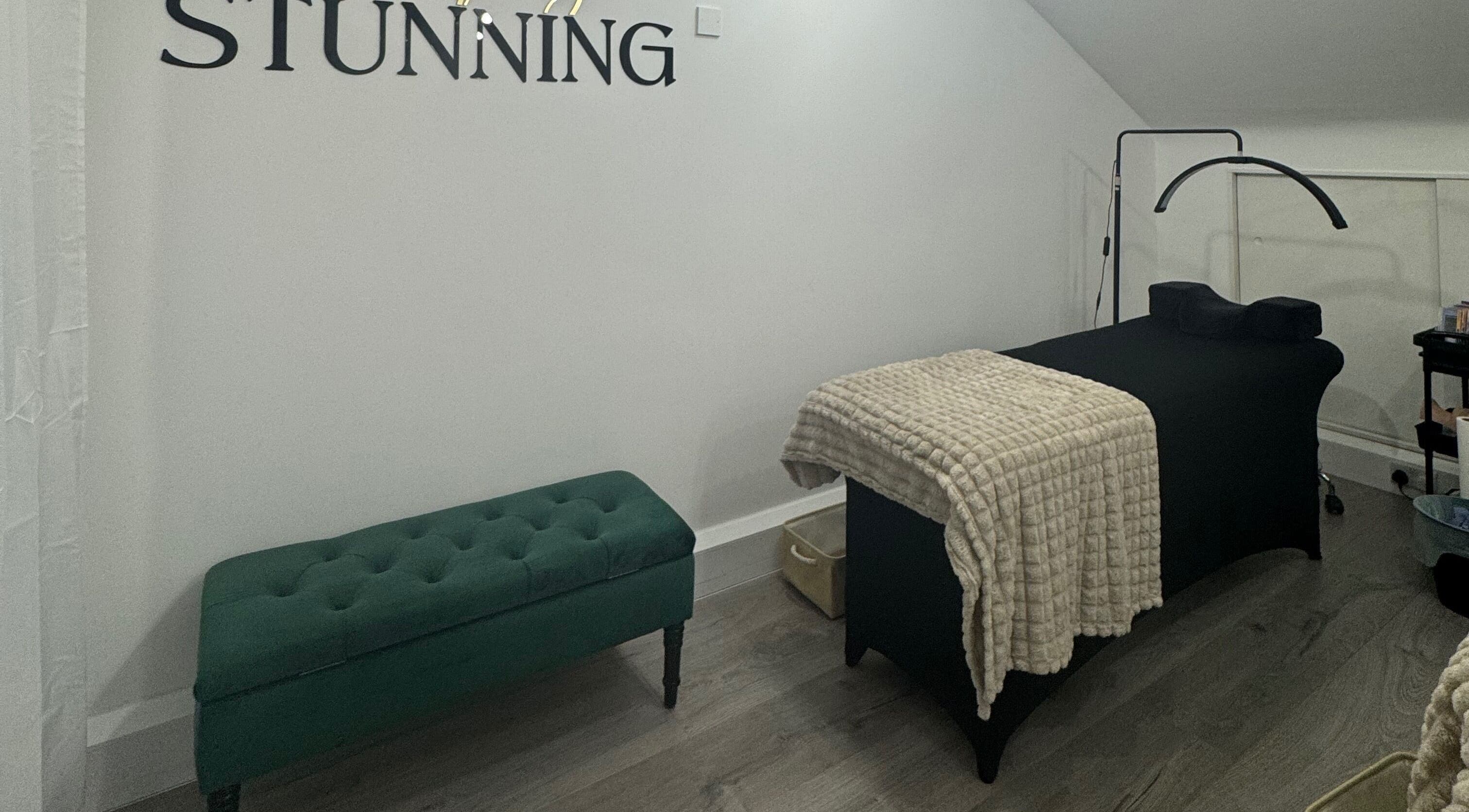 Calm treatment room at Simply Stunning, London, England, GB with massage table and elegant decor.