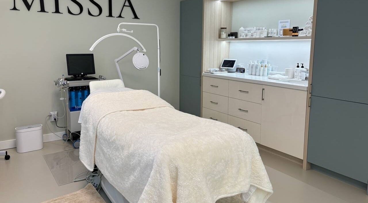 Calm treatment room at MISSIA beauty, Toronto, Ontario, CA, featuring a plush bed and elegant decor.