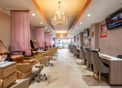 Luxurious interior of Fresh Nails & Spa in Glen Ellyn, Illinois, US with plush pedicure chairs and chandeliers.