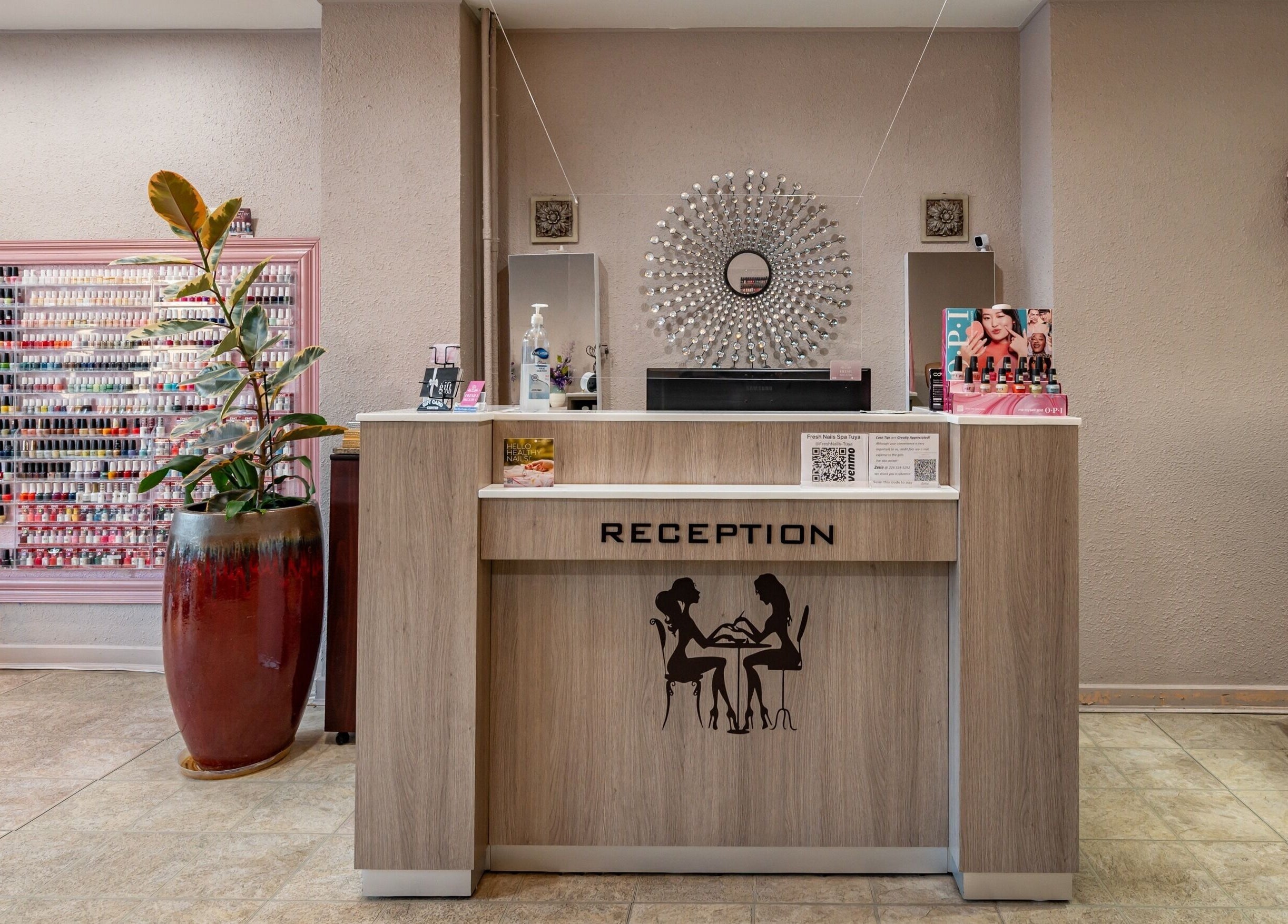 Reception area of Fresh Nails & Spa, Glen Ellyn, Illinois, US displaying nail polish rack and elegant decor.