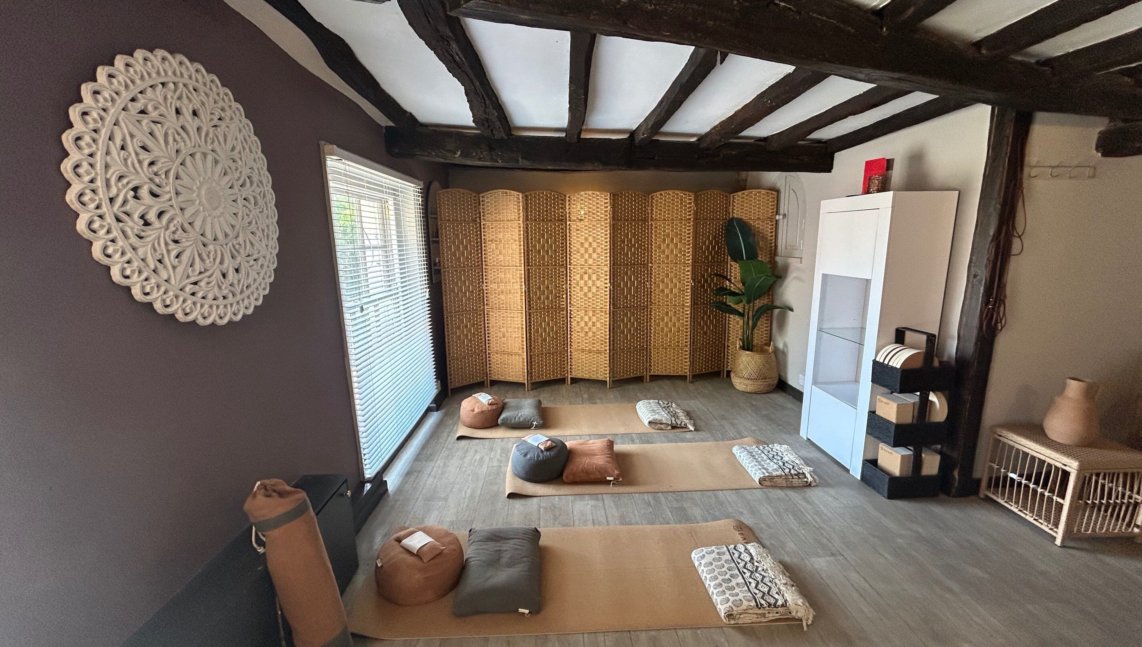 Cozy meditation room at Sanctum in Lincoln, England, GB with mats and woven decor for relaxation and tranquility.