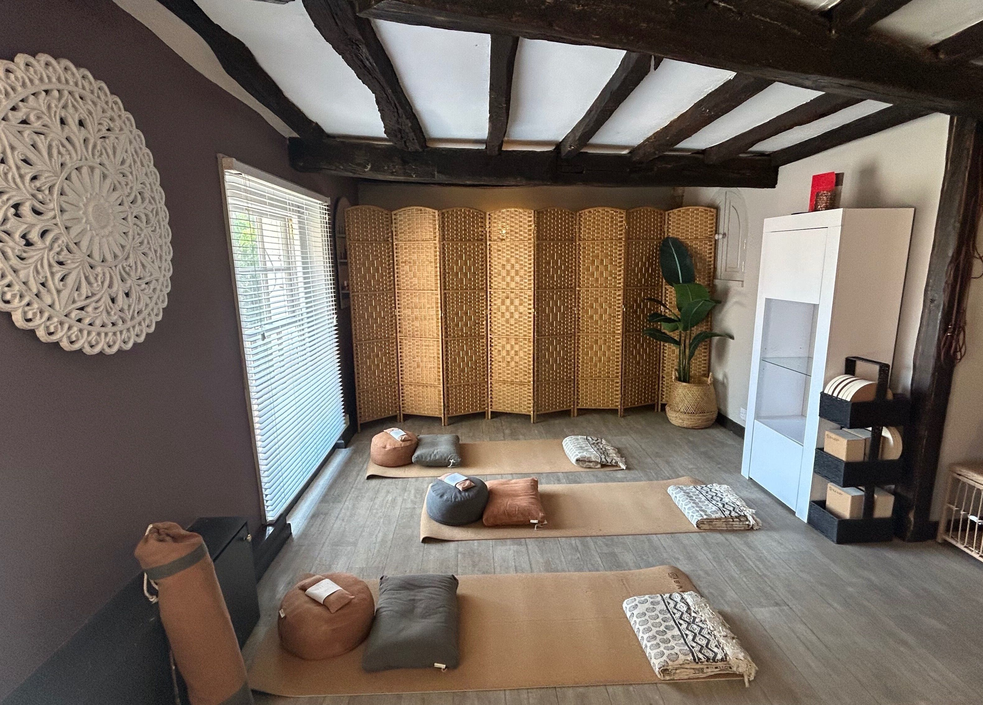 Cozy meditation room at Sanctum in Lincoln, England, GB with mats and woven decor for relaxation and tranquility.