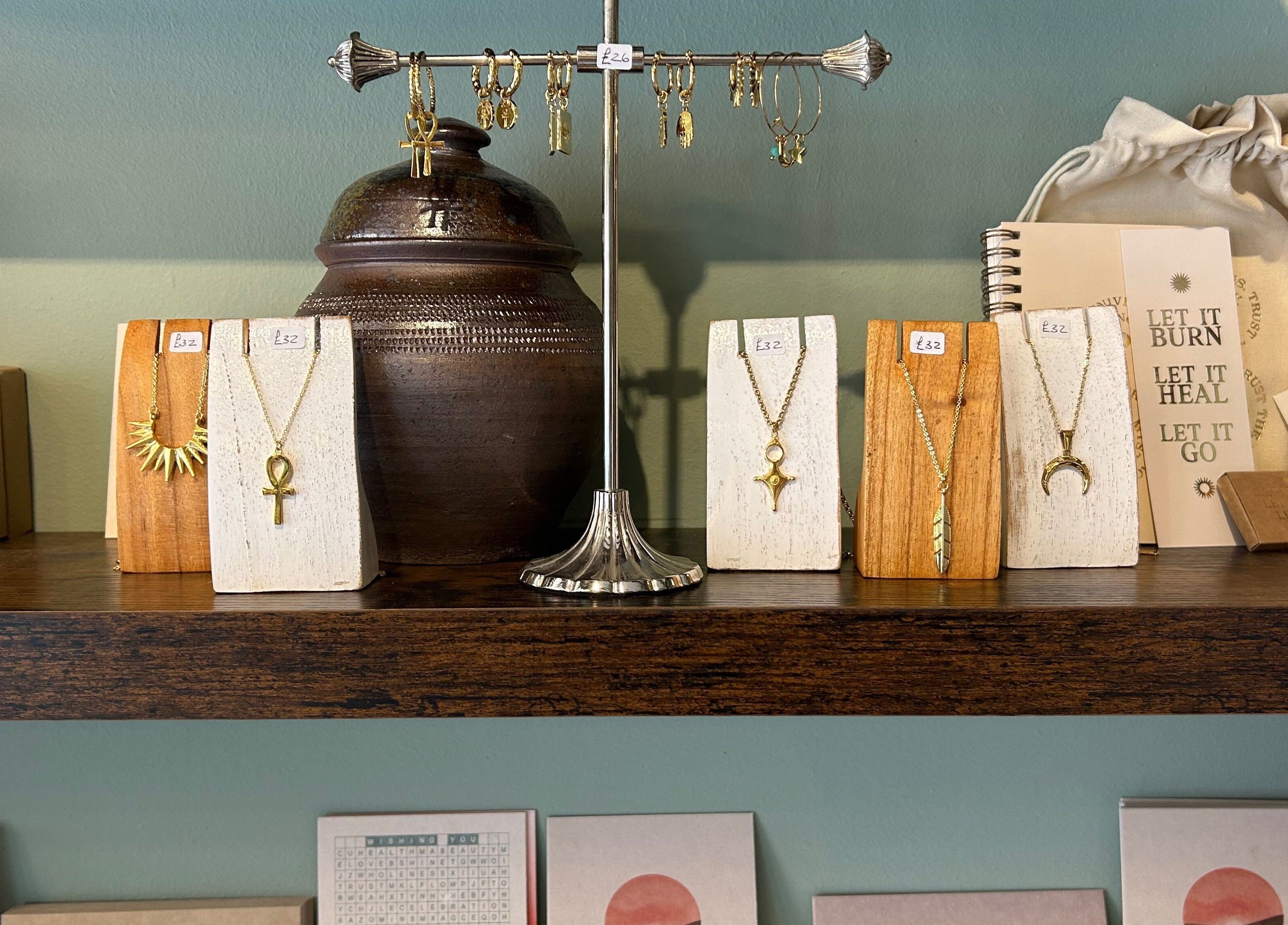 Assortment of gold jewelry displayed at Sanctum, Lincoln, England, GB enhancing boho-chic decor.
