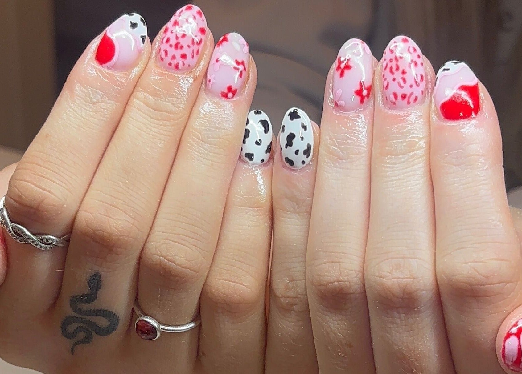 Vibrant nail art with pink and black patterns at Gels by Elise, Forres, GB.