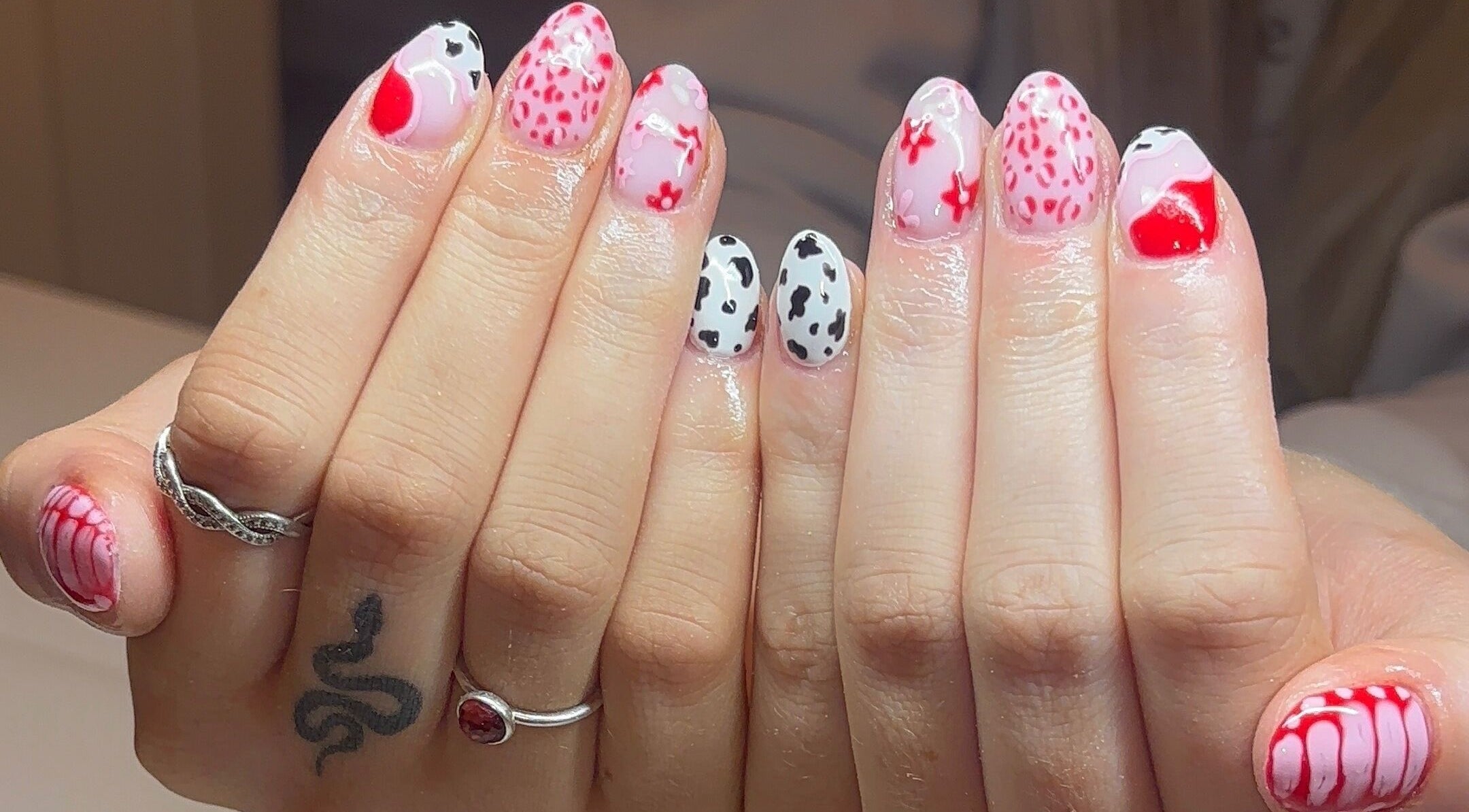 Vibrant nail art with pink and black patterns at Gels by Elise, Forres, GB.