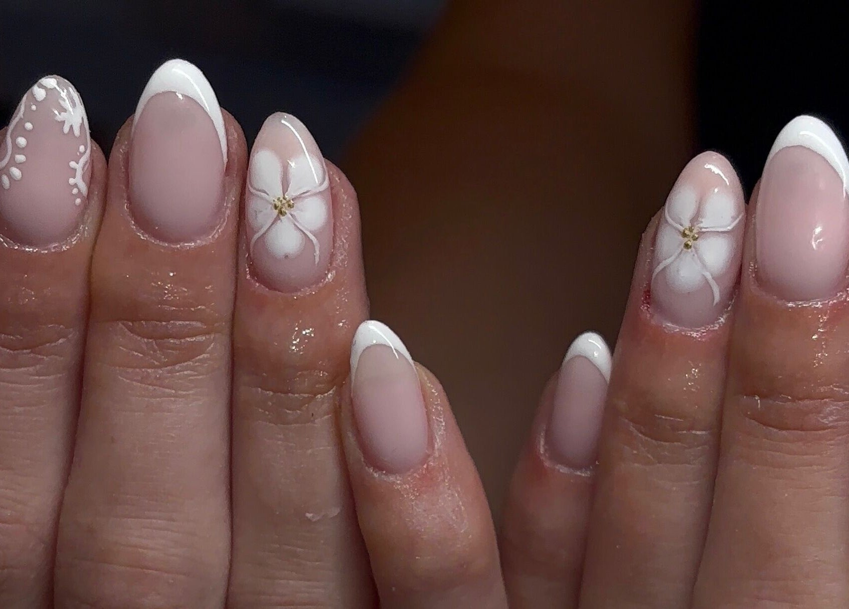 Elegant floral nail art by Gels by Elise, Forres, GB showcasing intricate white designs on gel nails.