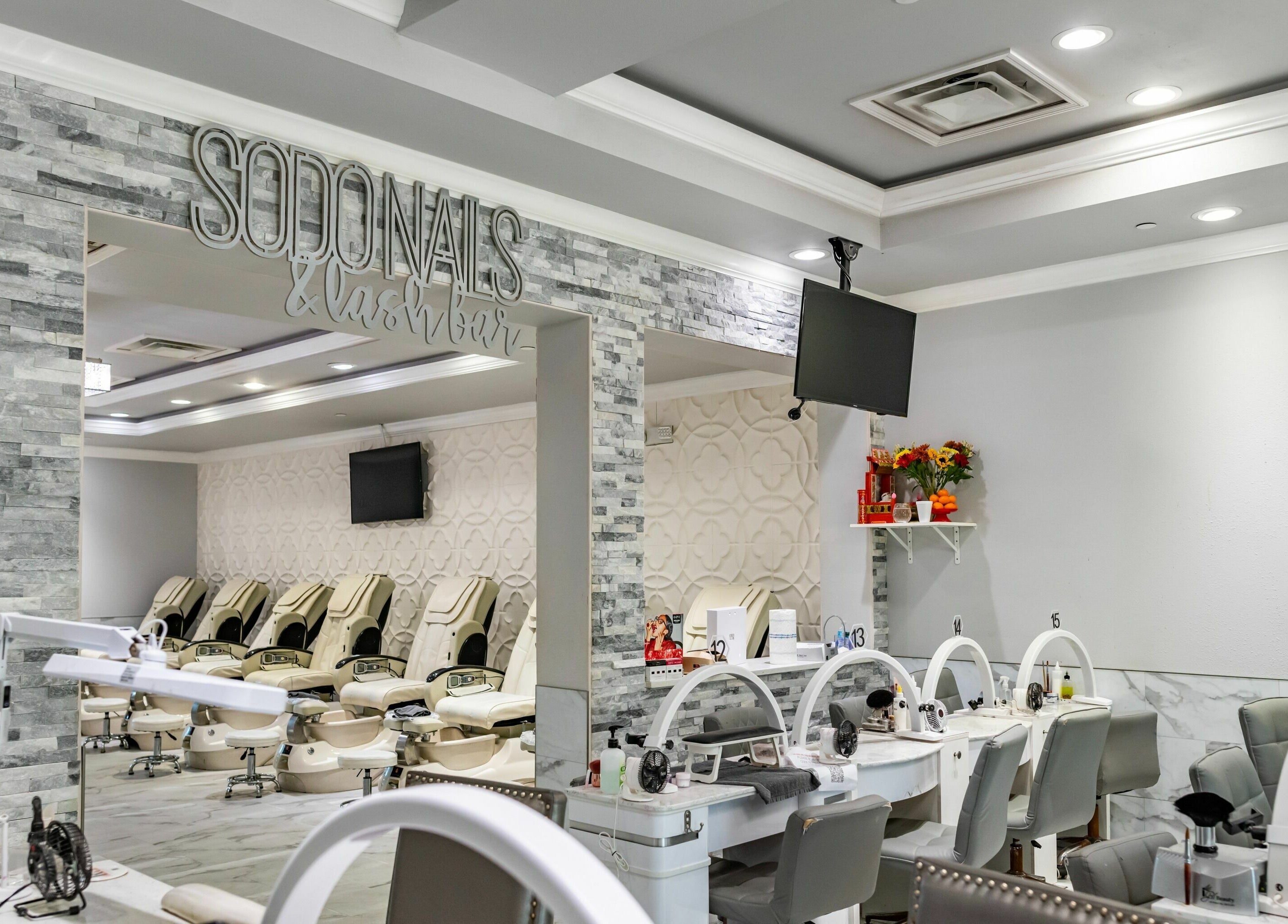 Interior view of SODO Nails & Lash Bar, Orlando, Florida, US, featuring modern decor and luxurious seating.