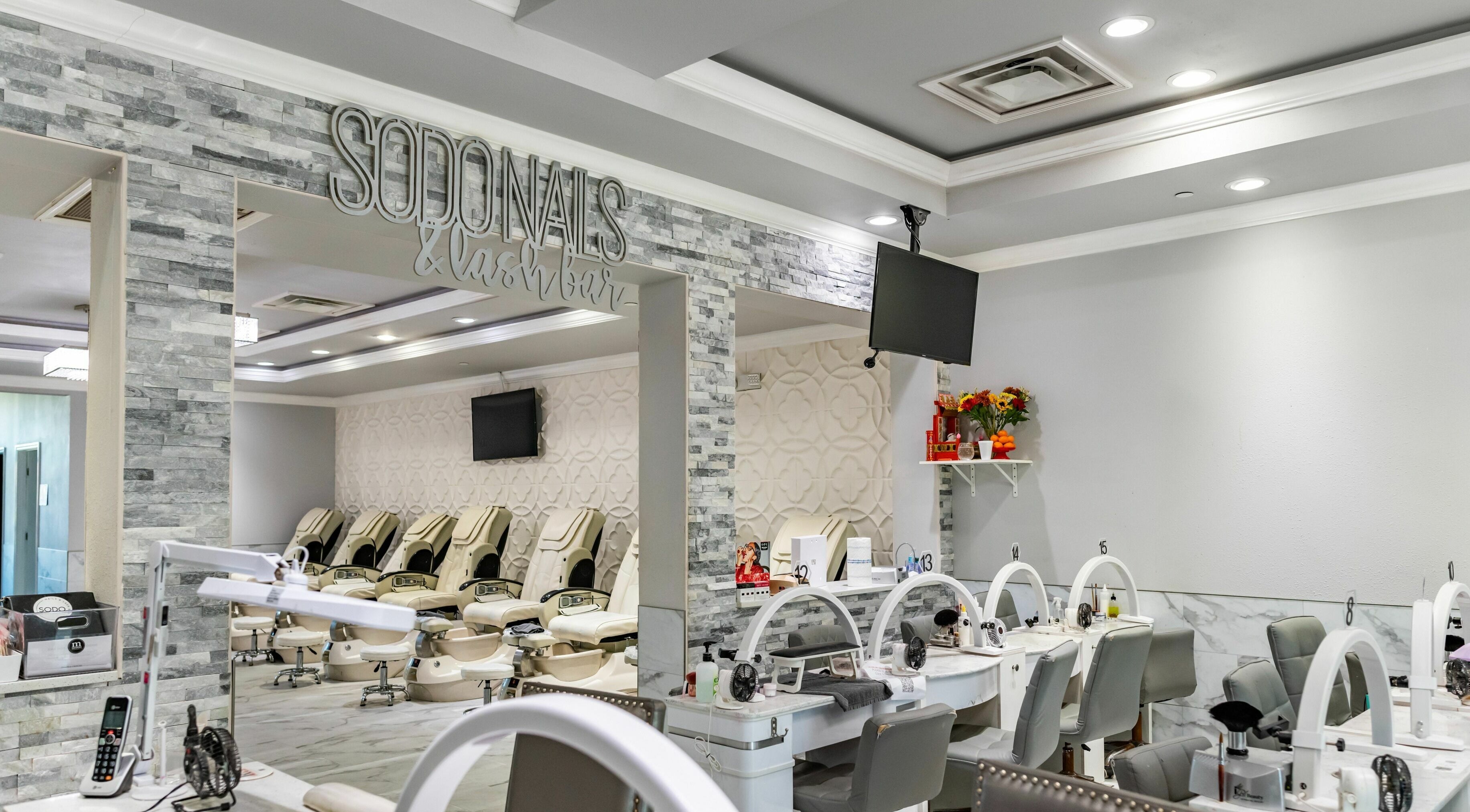 Interior view of SODO Nails & Lash Bar, Orlando, Florida, US, featuring modern decor and luxurious seating.