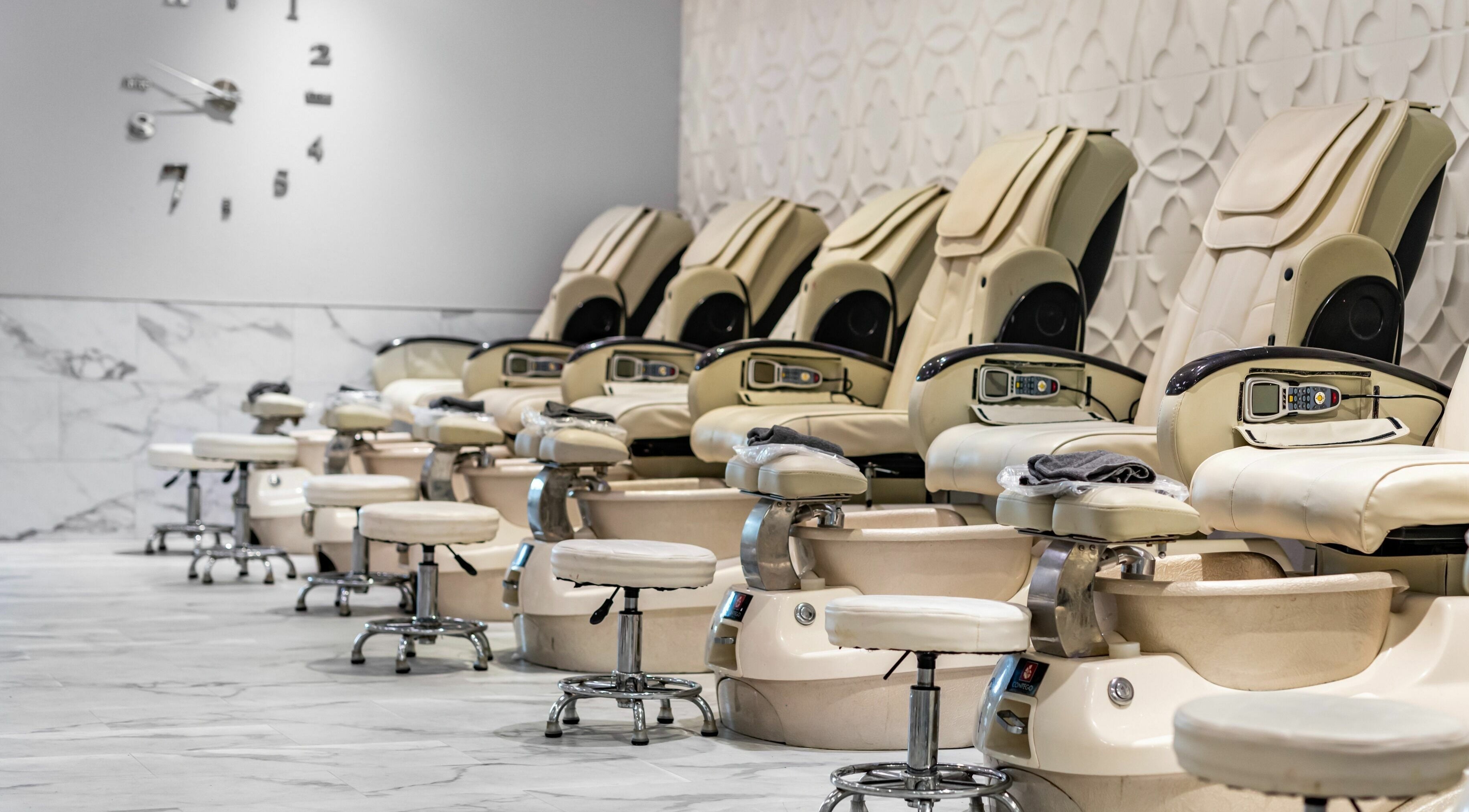 Pedicure chairs at SODO Nails & Lash Bar in Orlando, Florida, US, with a stylish, marble-finished interior.
