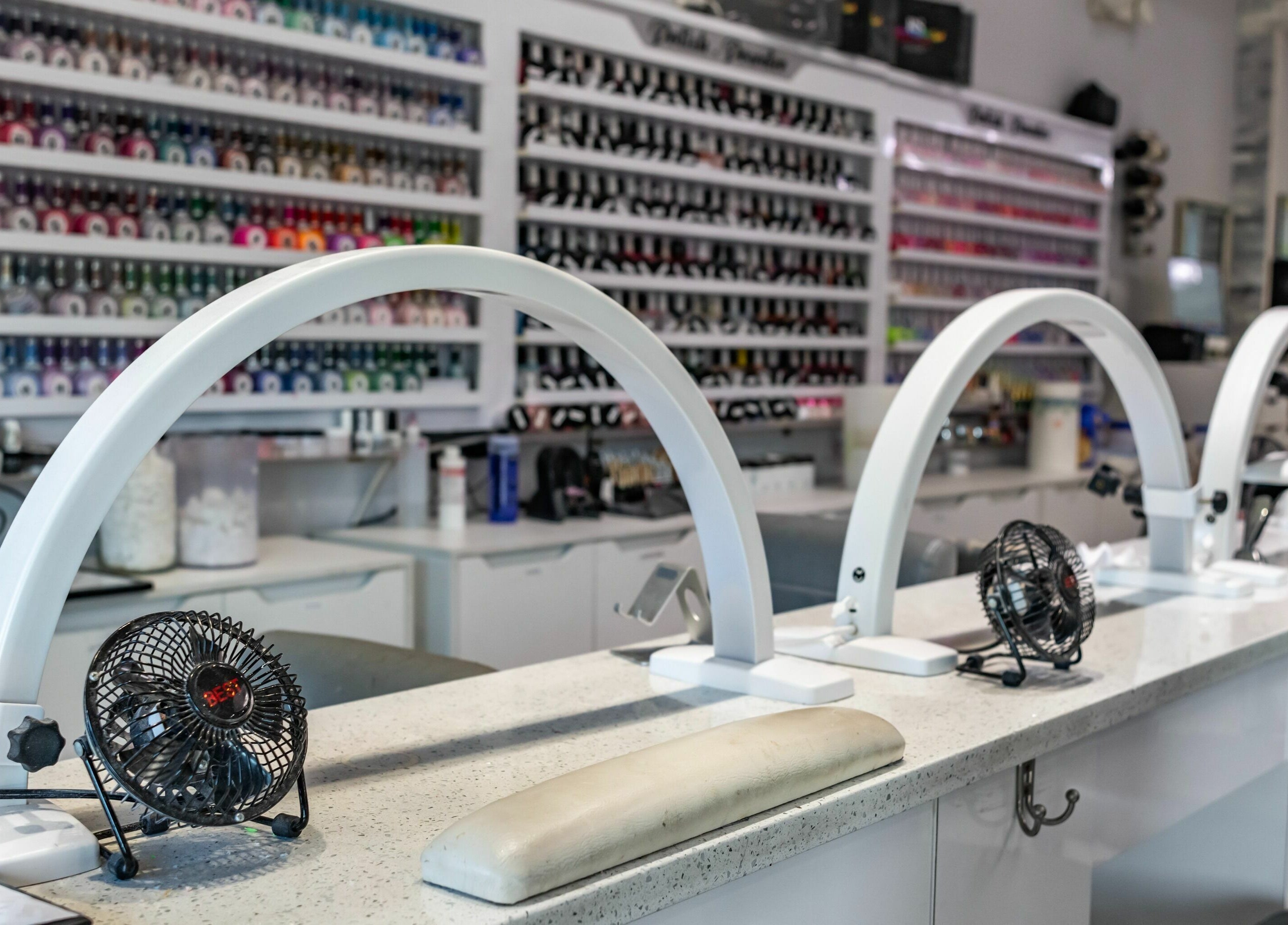 Manicure station with nail polish display at SODO Nails & Lash Bar, Orlando, Florida, US.