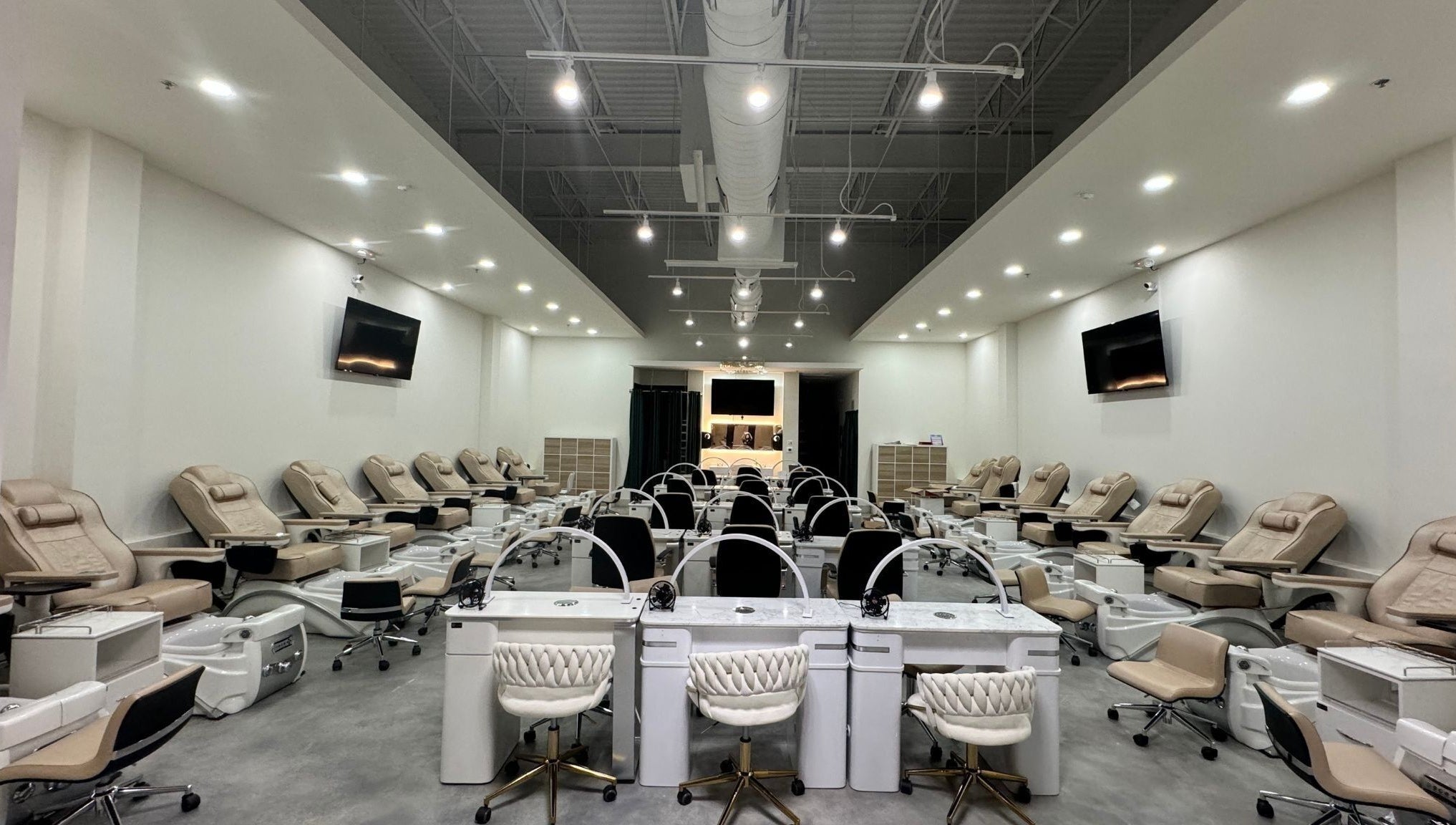 Spacious interior of Nails and Lash Garden in Winter Garden, Florida, US with elegant manicure stations.