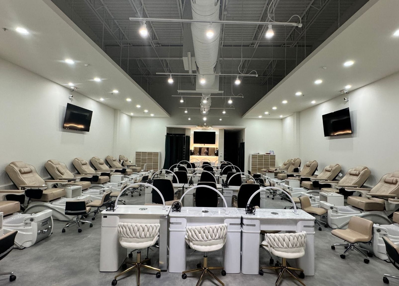 Spacious interior of Nails and Lash Garden in Winter Garden, Florida, US with elegant manicure stations.