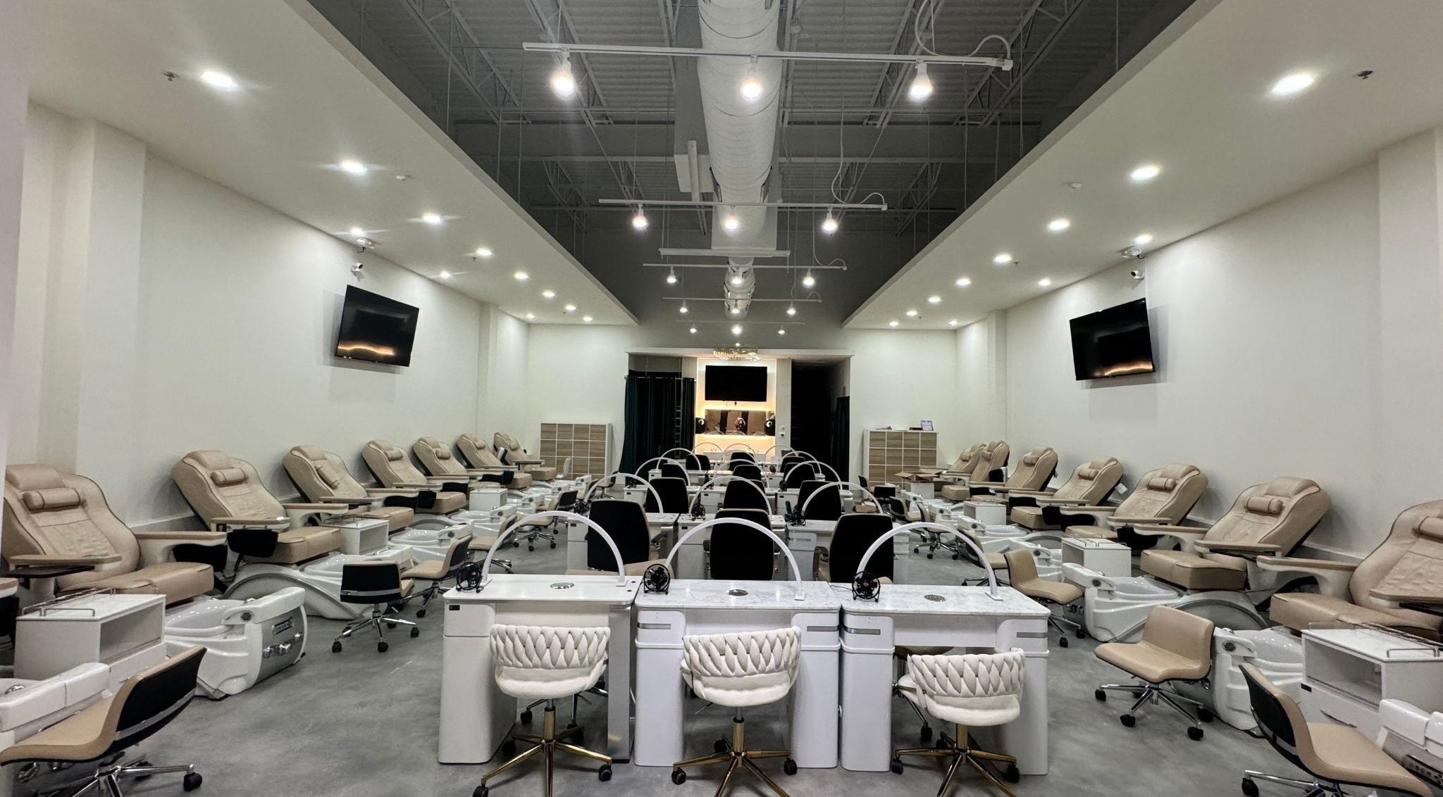 Spacious interior of Nails and Lash Garden in Winter Garden, Florida, US with elegant manicure stations.
