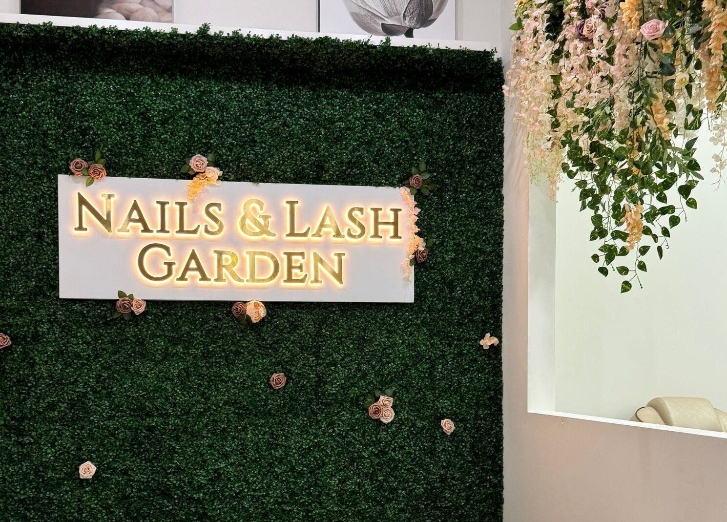 Entrance at Nails and Lash Garden, Winter Garden, Florida, US with floral decor and welcoming sign.