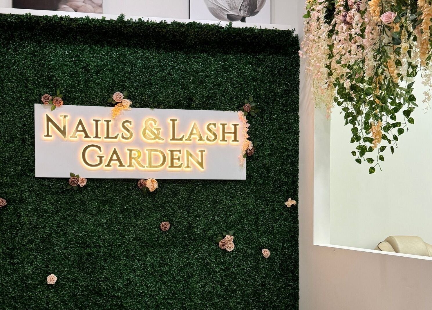 Entrance at Nails and Lash Garden, Winter Garden, Florida, US with floral decor and welcoming sign.