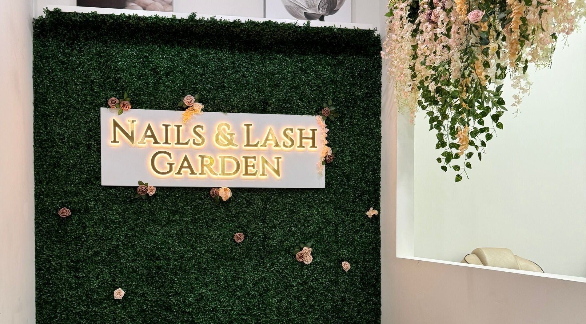 Entrance at Nails and Lash Garden, Winter Garden, Florida, US with floral decor and welcoming sign.