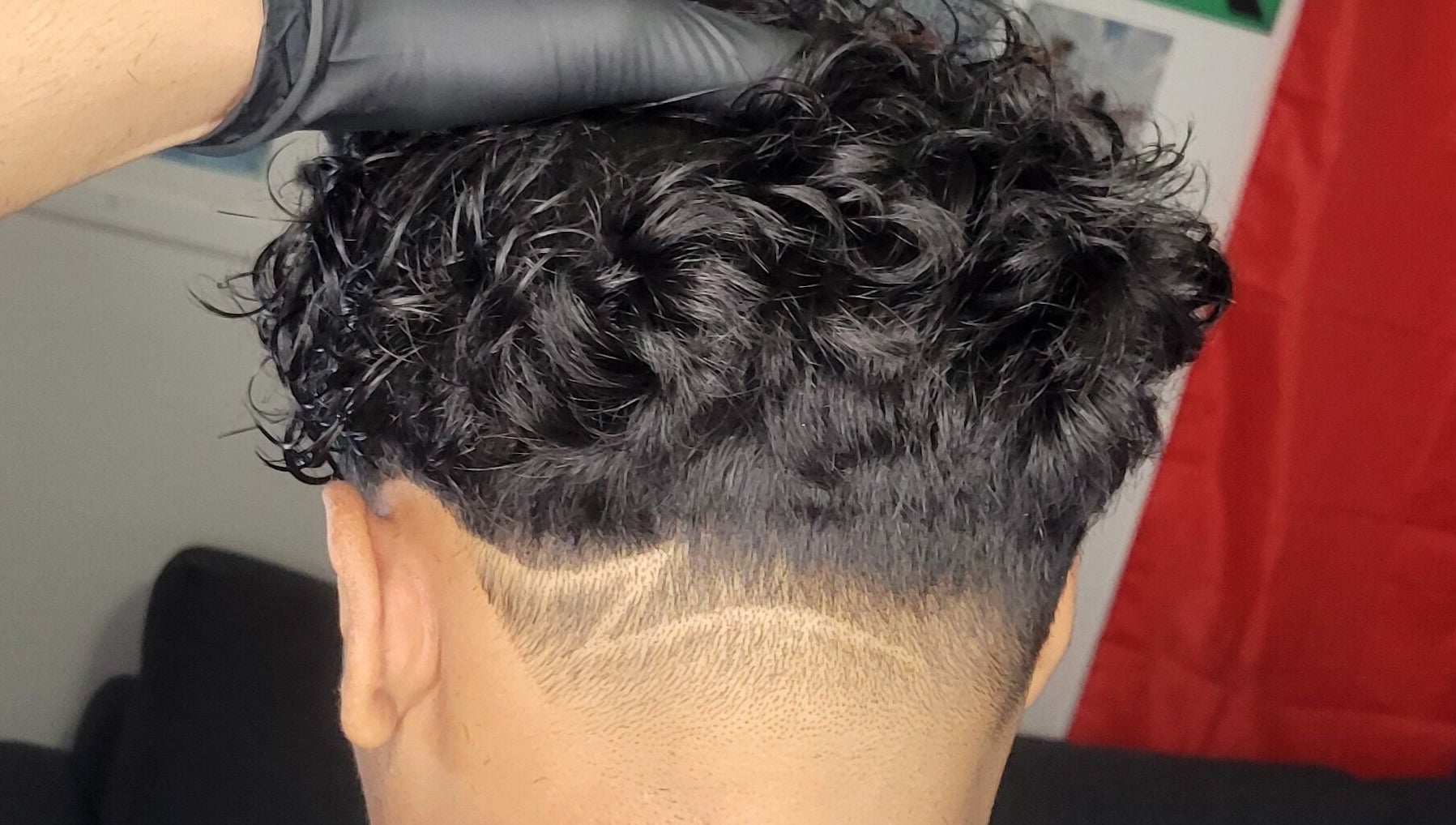 Stylish curly undercut at VINCE'S CHOPS, Montréal, Québec, CA, showcasing sharp detail.