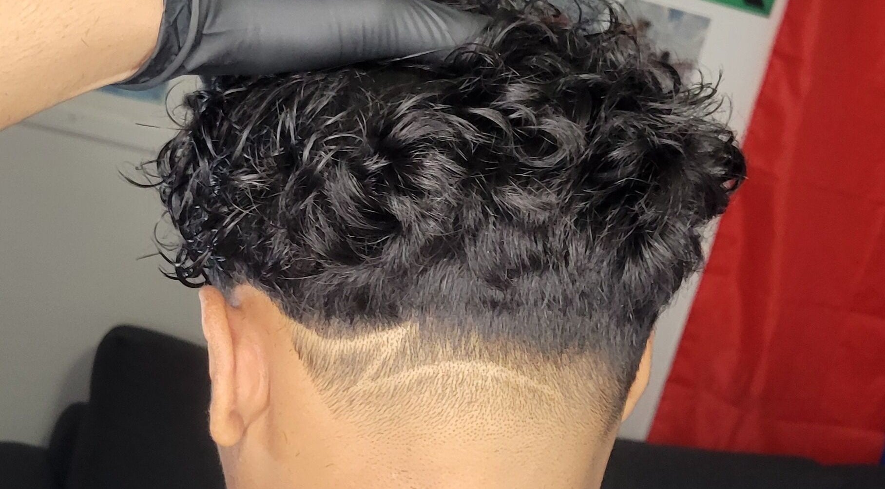 Stylish curly undercut at VINCE'S CHOPS, Montréal, Québec, CA, showcasing sharp detail.