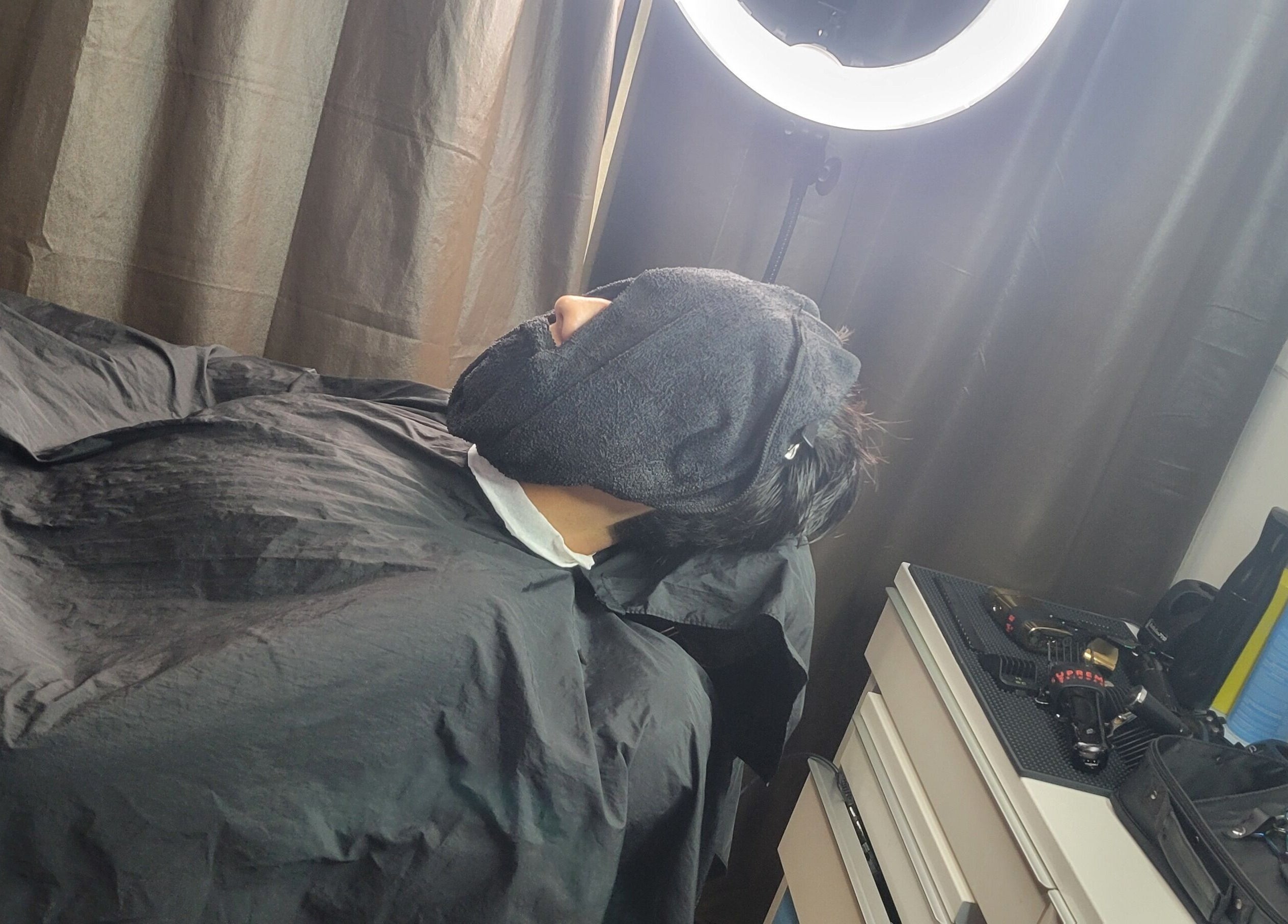 A person enjoys a relaxing facial treatment at VINCE'S CHOPS in Montréal, Québec, CA.