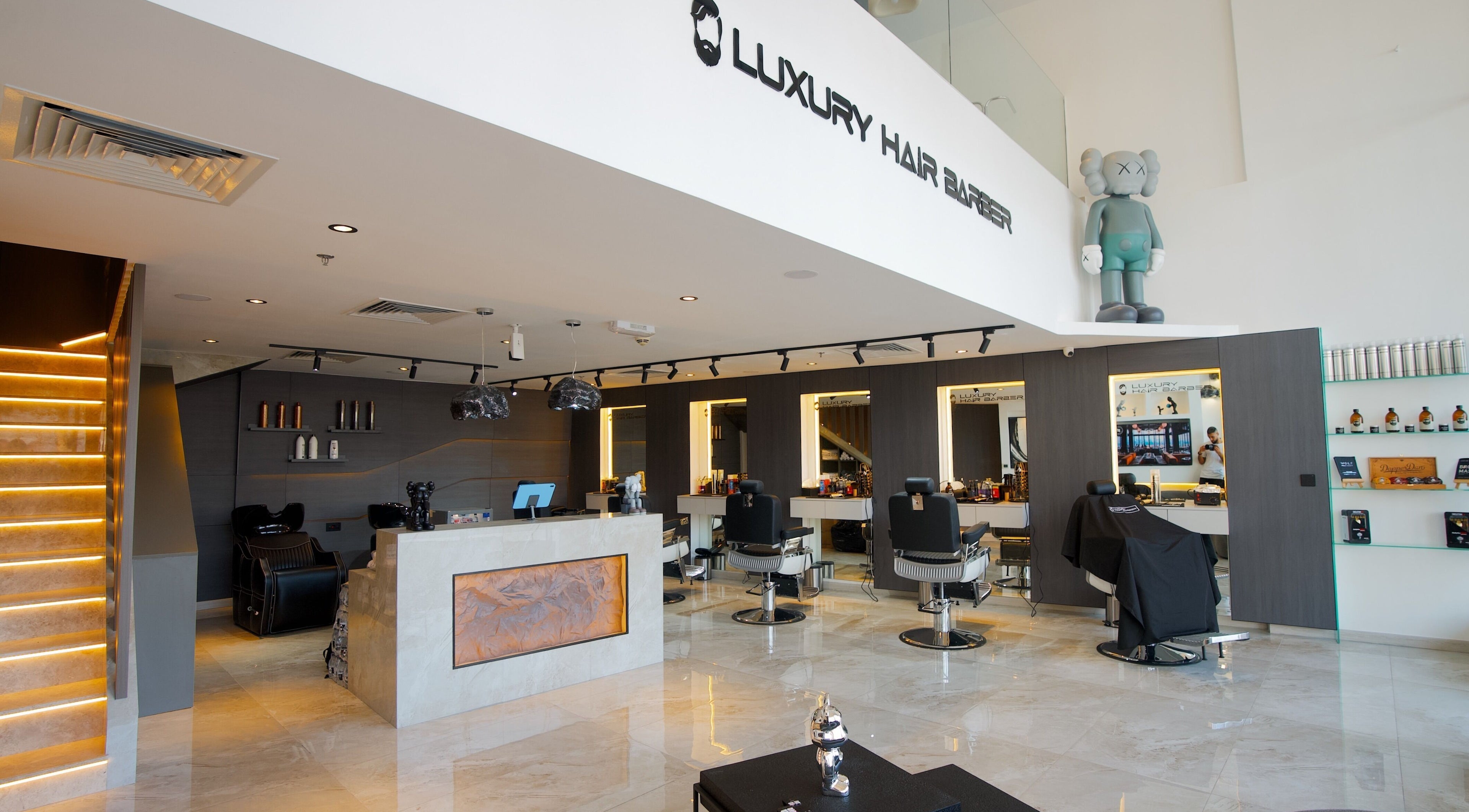 Modern interior of Luxury Hair Barbershop in Dubai, Dubai, AE with sleek design and styling stations.