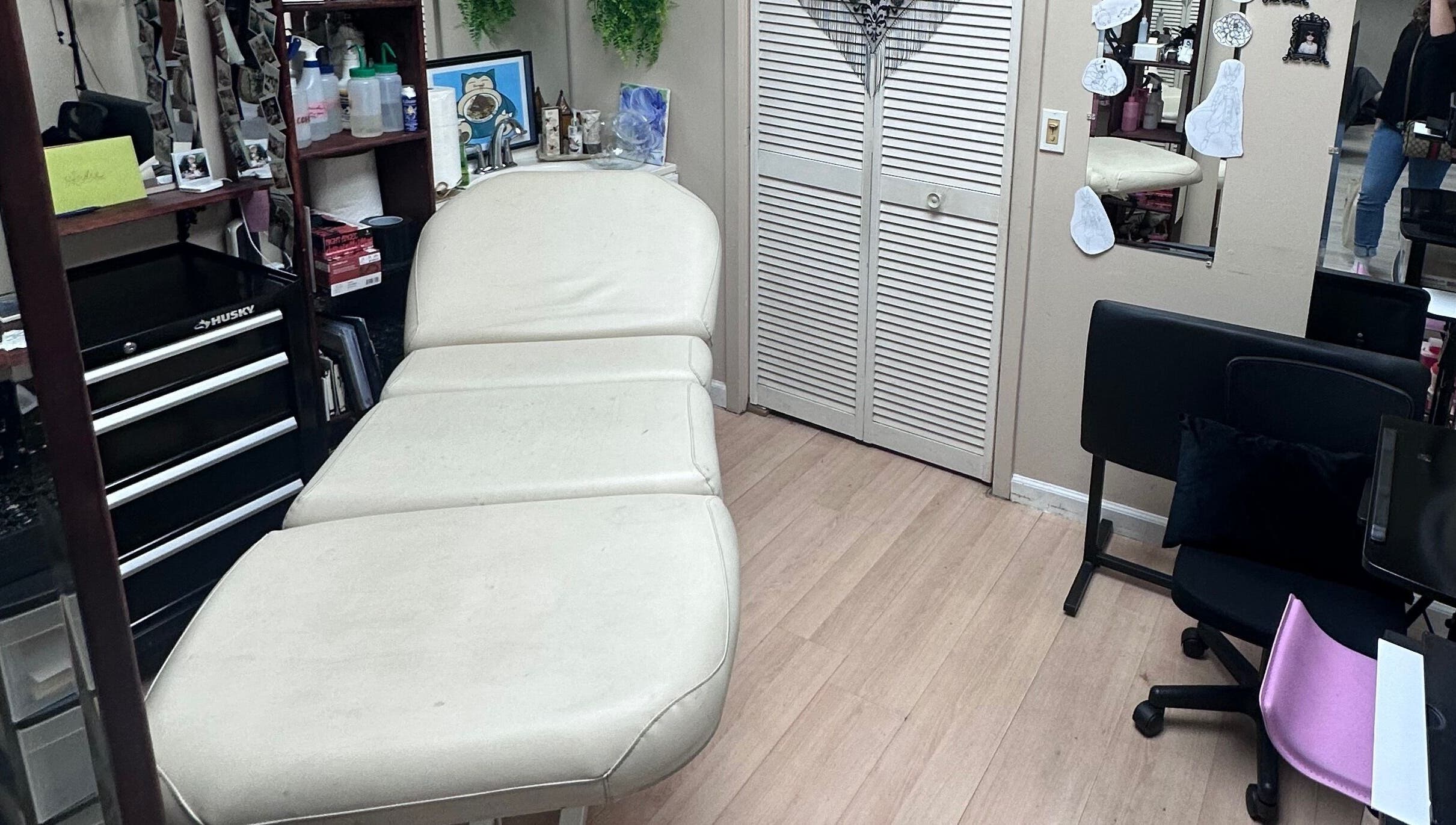 Cozy interior of K. Tabone Tattoo in Rochester, New York, US with a comfortable treatment bed.