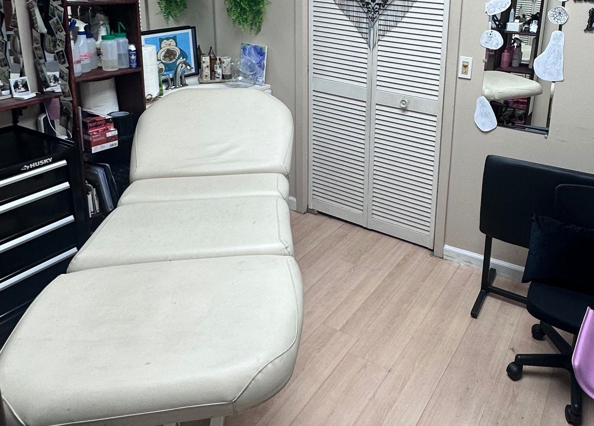 Cozy interior of K. Tabone Tattoo in Rochester, New York, US with a comfortable treatment bed.