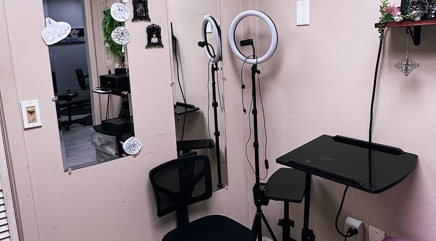 Tattoo station at K. Tabone Tattoo, Rochester, New York, US featuring chair, ring light, and mirror.