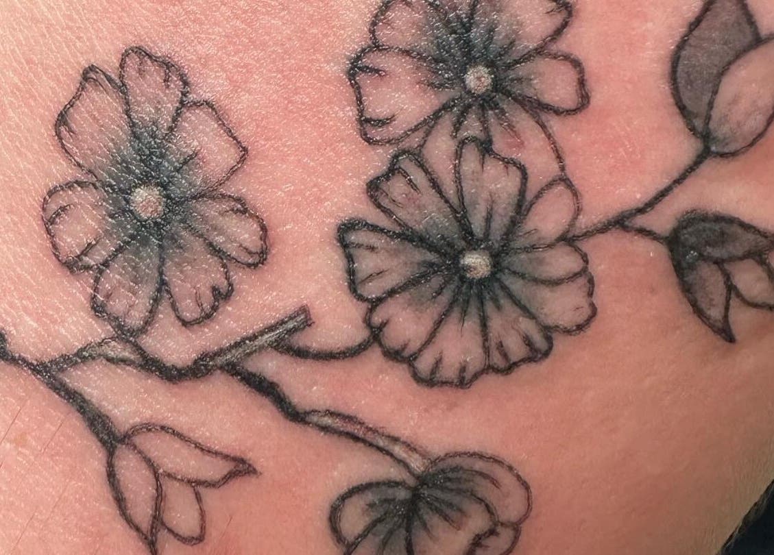 Delicate floral tattoo art at K. Tabone Tattoo in Rochester, New York, US showcasing intricate design.