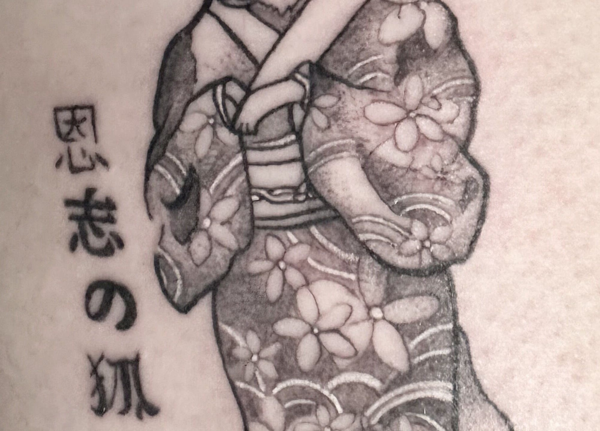 Ornate tattoo of a kimono-clad figure at K. Tabone Tattoo, Rochester, New York, US.