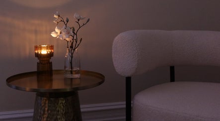 Cozy relaxation setting at The Head Spa Perth in South Perth, Western Australia, AU with candle and armchair.