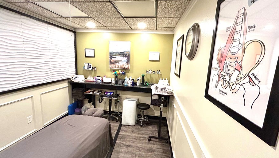 Calming treatment room at Revive Integrative Wellness | Abilene, Texas, US, with massage table and artwork.