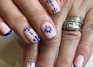 Elegant floral nail art by Beauty By Eloise in Godshill, England, GB featuring blue petals and gold accents.
