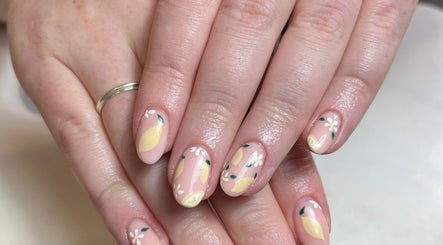 Lemon-themed nail art at Beauty By Eloise, Godshill, England, GB. Delicate floral designs enhance the nails.
