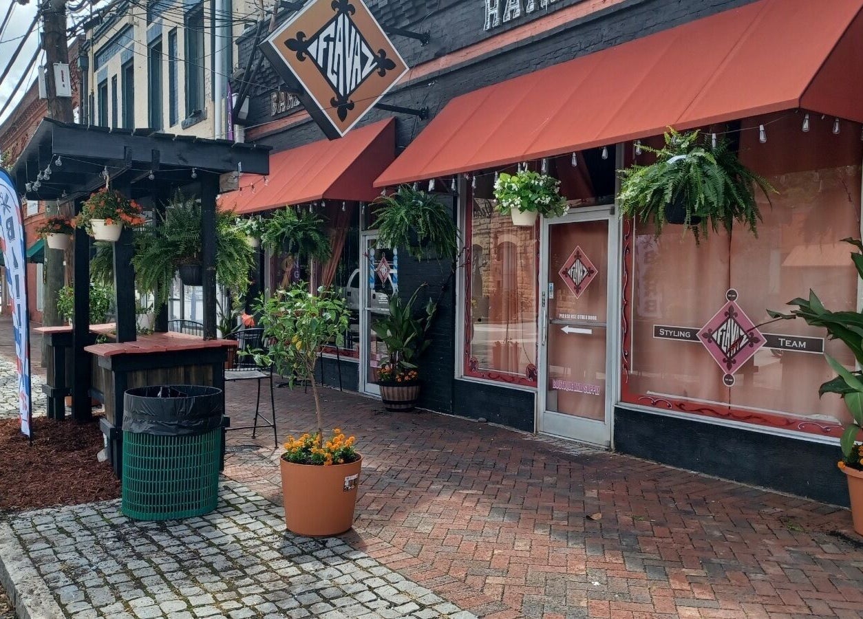 Locz by Lola's inviting facade with vibrant flowers in Lithonia, Georgia, US.