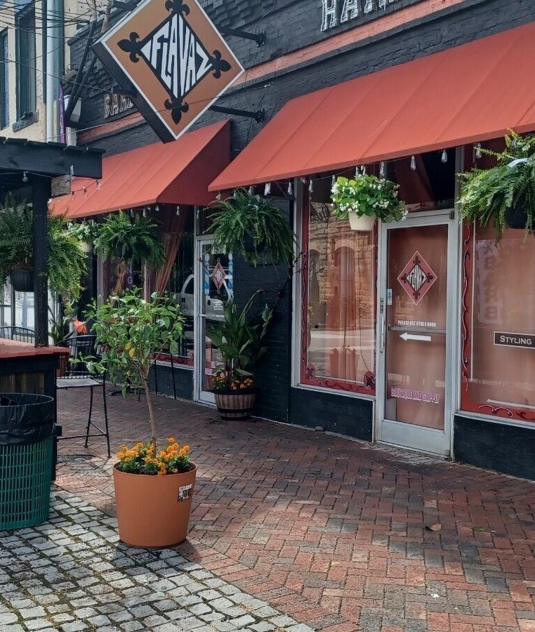 Locz by Lola's inviting facade with vibrant flowers in Lithonia, Georgia, US.