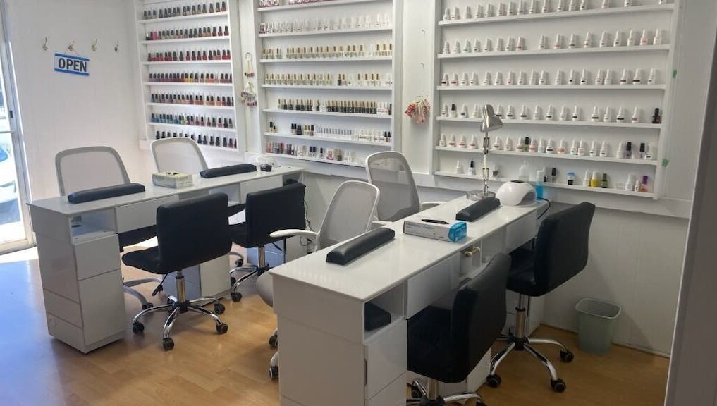 Modern nail salon interior at Rejoice Nails X Spa, Belleville, Ontario, CA, showcasing manicure stations.